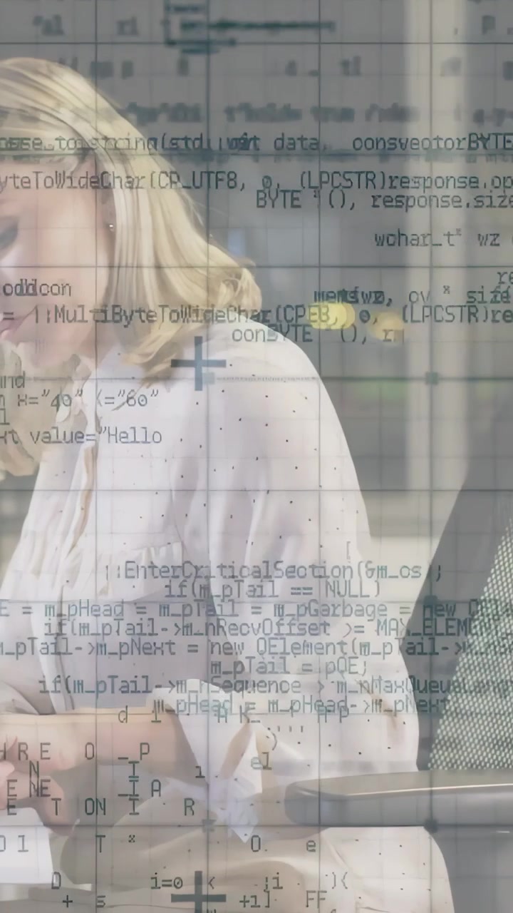 Vertical video: Woman picking up pen and writing at desk, reviewing tech notes with code overlay