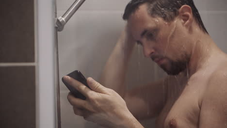 man using smartphone in shower