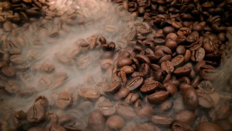 Close-up-of-seeds-of-coffee.-Fragrant-coffee-beans-are-roasted-smoke-comes-from-coffee-beans.