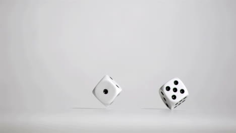 pair of white dice in super slow motion bouncing