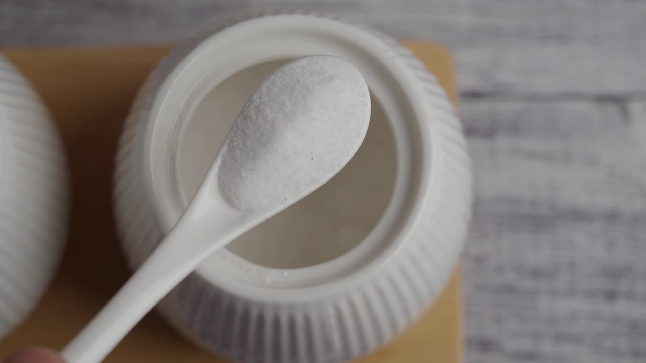 White ceramic salt container with spoon