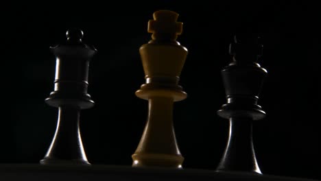 cinematic roll shot of 3 chess pieces turning