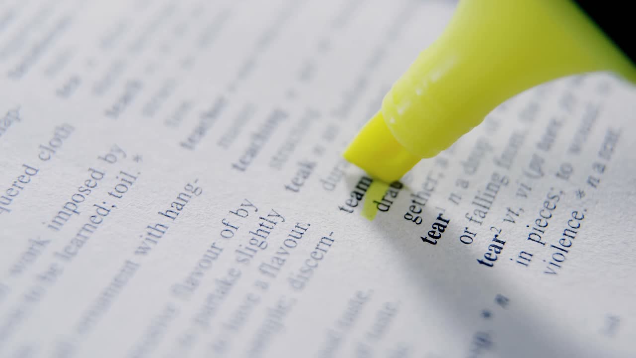 Close-up of marker pen highlighting text