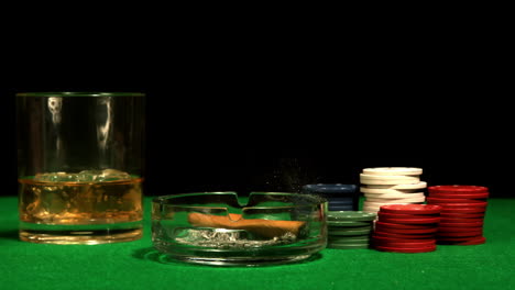 Cigar-falling-into-ashtray-on-casino-table