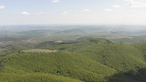 forested hills in region near piatra secuiului, romania, aerial, wide angle establishing view, background with copy space