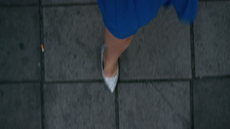 woman walking on sidewalk wearing elegant evening party dress stylish glitter shoes strolling in urban city nightlife