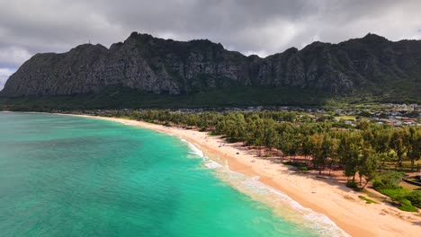 turquoise ocean water with cloudy skies at waimānalo beach in oahu hawaii, aerial