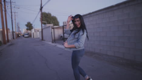 Happy-young-woman-walking-through-the-alley-as-an-inviting-way