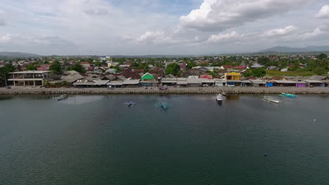 drone fly over jempol beach, sumbawa island, indonesia. traditional fisherman boat and little rural village unique travel destination