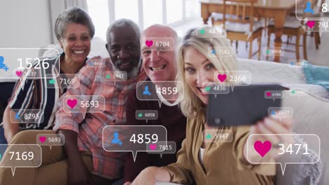 animation of media icons over diverse group of seniors taking selfie