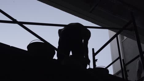 silhouette of construction worker with cement trowel