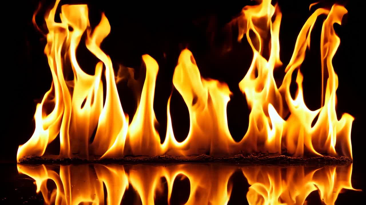A close up of a fire burning in the dark