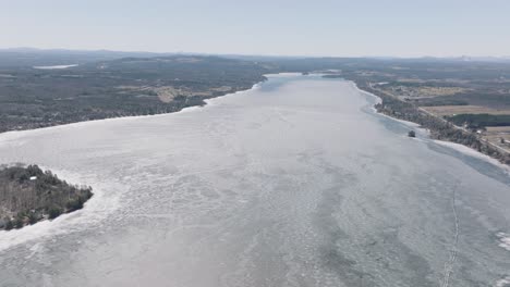 aerial view of vast frozen water of magog lake in quebec, canada