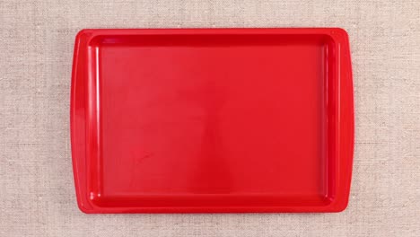 organic vegetables and fruits appear in tray on kitchen table. stop motion