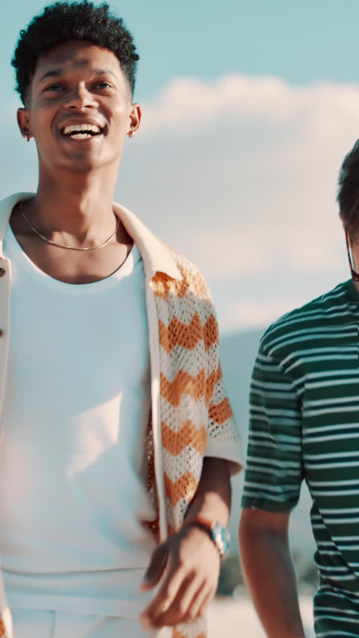 Two Young Men Talking and Laughing Outdoors on a Sunny Day