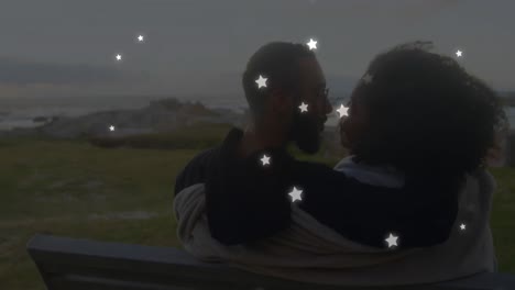 animation of stars over diverse couple embracing