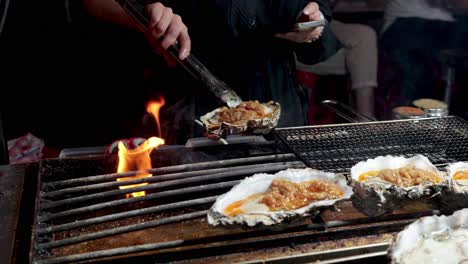 oysters being grilled with flames in hong kong