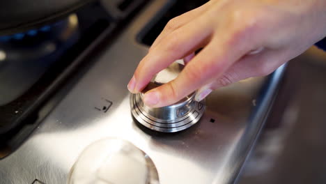 Chef-turning-up-the-heat-on-a-kitchen's-stovetop-in-slow-motion