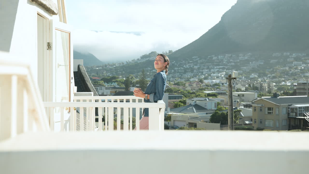 woman enjoying morning coffee on balcony overlooking scenic mountain view, copy space