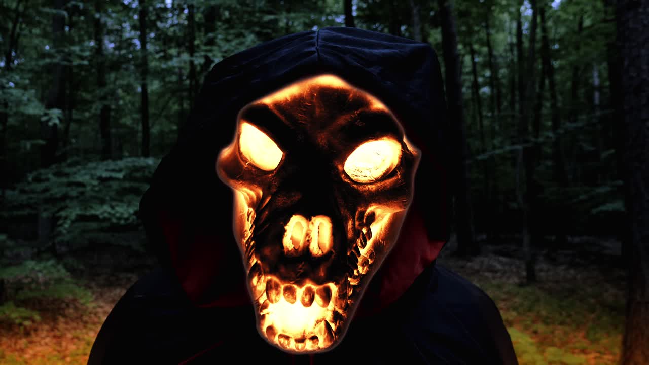 vista de cerca de la cara del cráneo del ángel de la muerte en llamas en el bosque