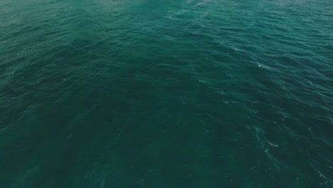 Slow-aerial-Move-in-to-reveal-cliff-at-Shipwreck-Beach-Hawaii