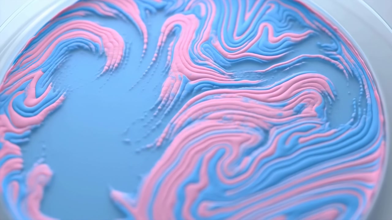 Primo piano da una vista dall'alto obliqua che mostra un piatto poco profondo riempito con crema azzurro pastello, mentre creste rosa stratificate formano motivi a onda fluidi su una superficie liscia.