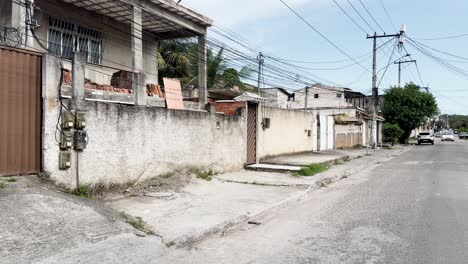 image of a street in a poor brazilian neighborhood, featuring graffitied walls and unfinished houses. the scene highlights urban decay, economic struggle, and everyday life in an underdeveloped area.