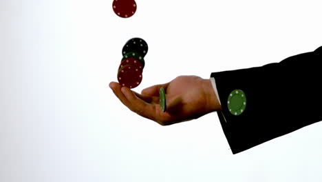 man in suit catching casino chips