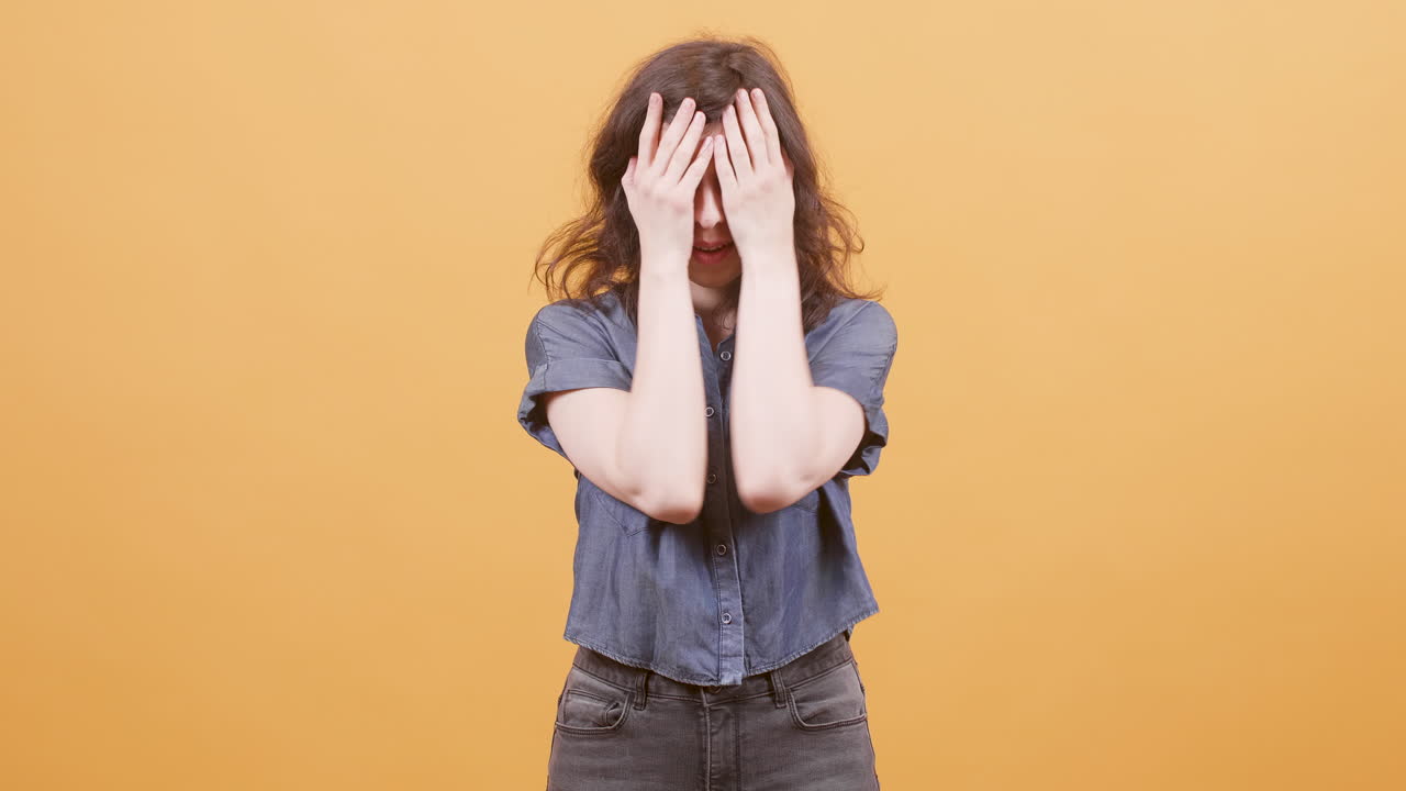 A woman with a range of facial expressions on an orange background