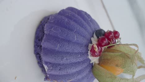 elegant purple dessert with fresh berries and physalis