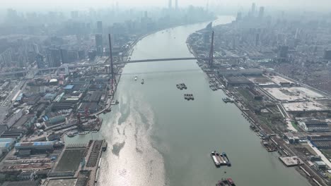 huangpu river and industry area with lujiazui downtown in background