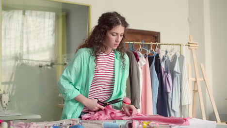 dressmaker cutting fabric.