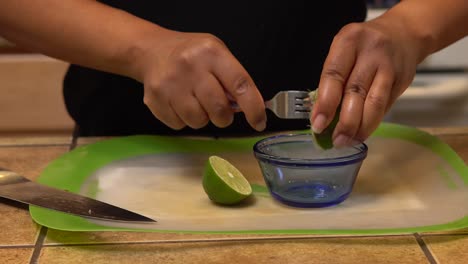 Juicing-limes-for-a-homemade-recipe---isolated-close-up