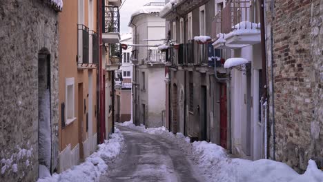 view of the narrow streets of guardiagrele in winter with snow, abruzzo, italy