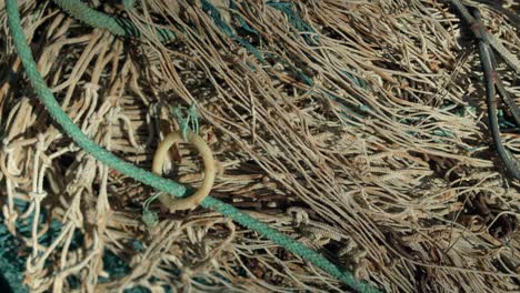 close shot of piled and entangled fishing nets in a boat