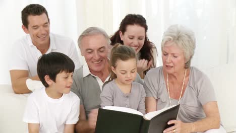 smiling family looking at a photograph album