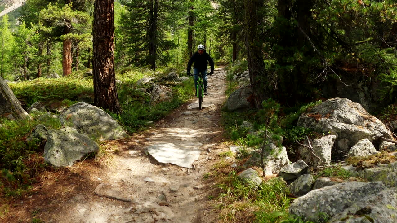 Mountain biker on a rocky forest trail