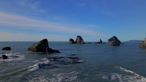 rugged rocky shore cliffs off the coast in tasman sea in new zealand