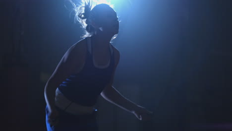 close-up of a boxer girl's face jumping on a rope during an active workout