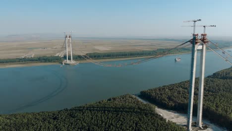 Main-Towers-Of-Braila-Tulcea-Bridge-Stands-On-The-Riverbanks-Of-Danube-River-In-Romania
