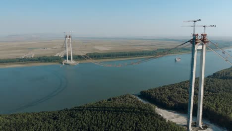 main towers of braila-tulcea bridge stands on the riverbanks of danube river in romania