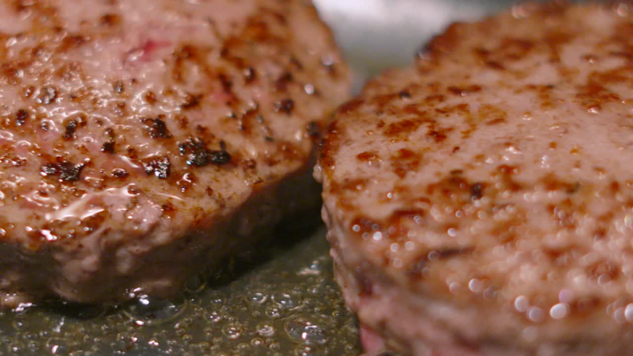 Top View Slow Moving Shot Over Juicy Beef Burgers in Pan. Close Up Meat Cutlet Frying