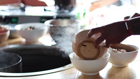 sequential preparation of a noodle soup bowl