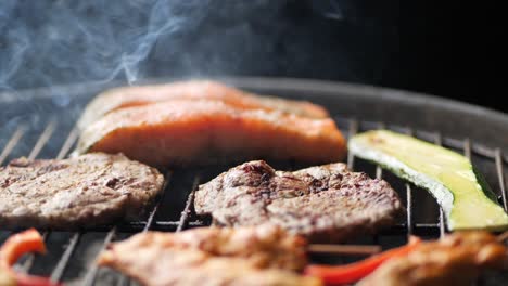 slow camera movement over the smoky meat and vegetables on the grill