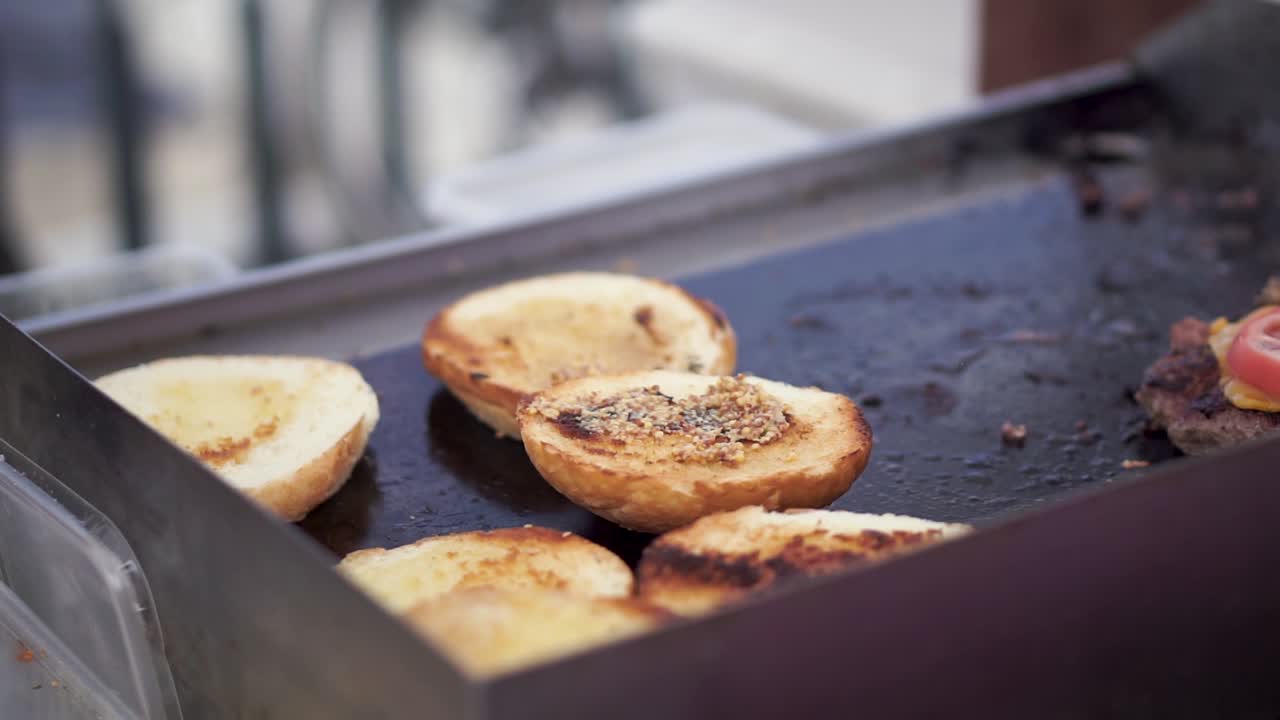 Tilbereder gourmetburgere på en food truck