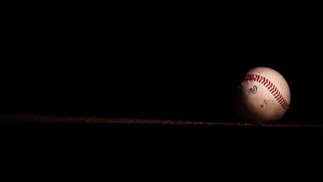 dirty baseball drops onto field at night