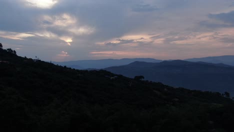 Aerial-view-of-the-sunset-over-the-mountains-in-the-village-of-el-Colegio,-Colombia