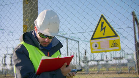 supervisor reading work report outside secured hazardous location