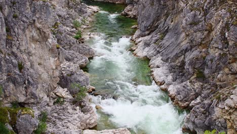 tilt shot of a beautiful river in norway cascading through a mountainous canyon