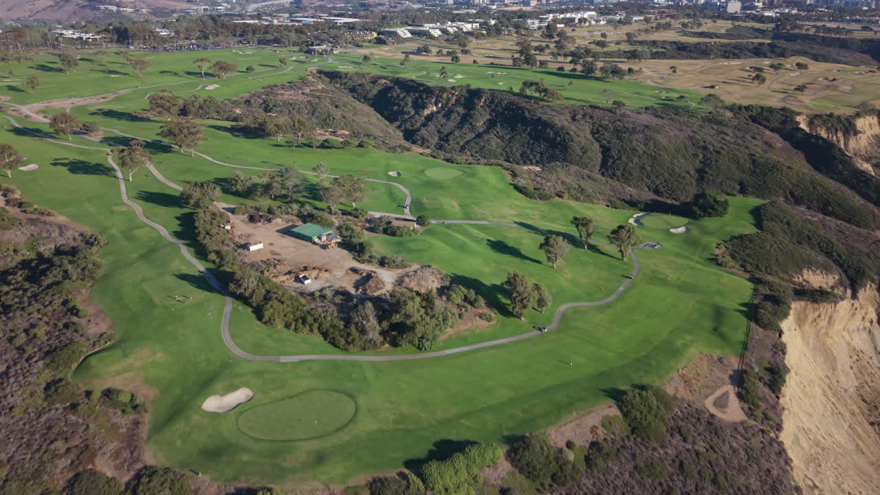 Aerial drone view of Torrey Pines Golf Course in La Jolla, California. Tilt-up reveal shot